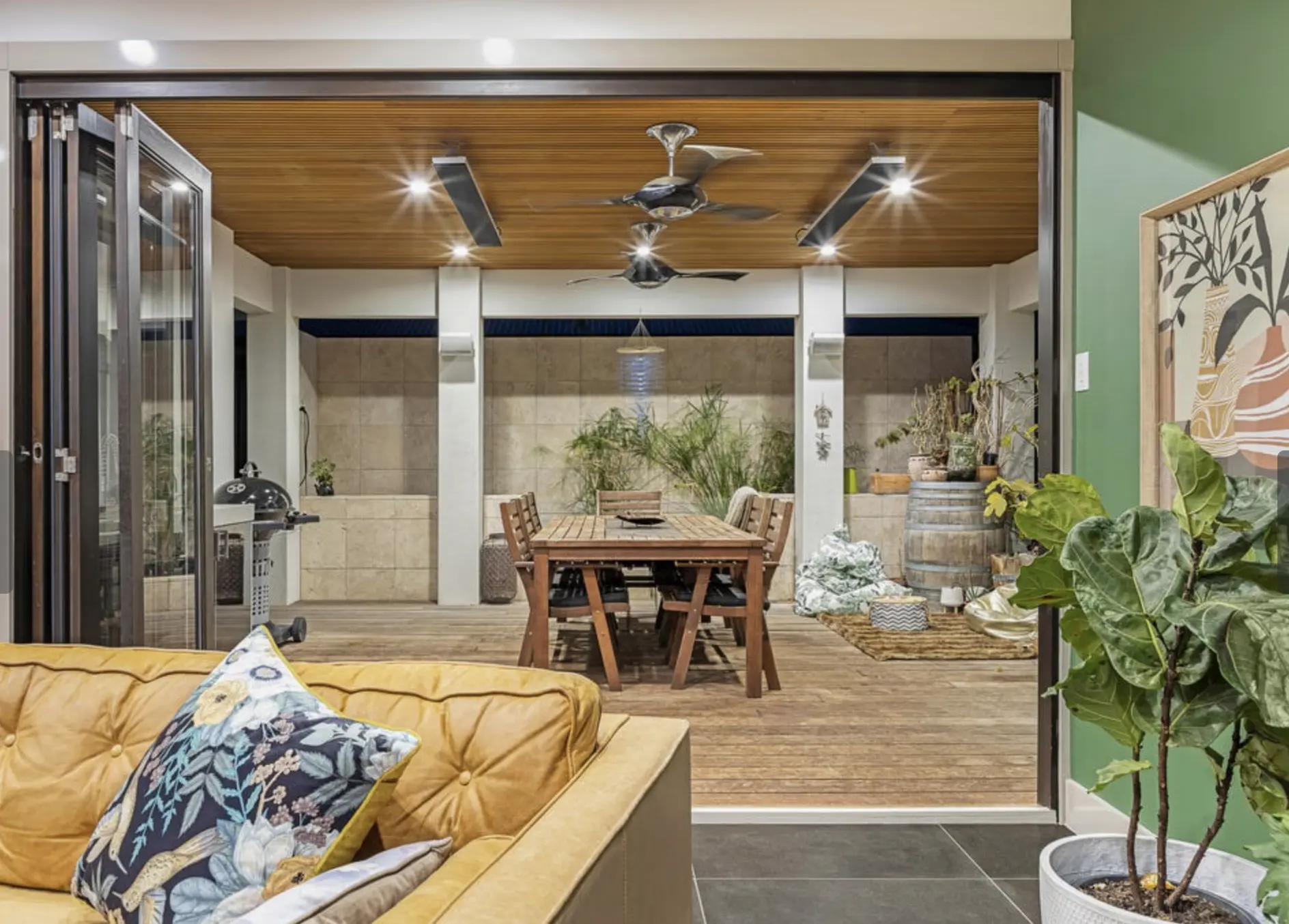 Indoor outdoor dining space with timber ceiling and bifolds