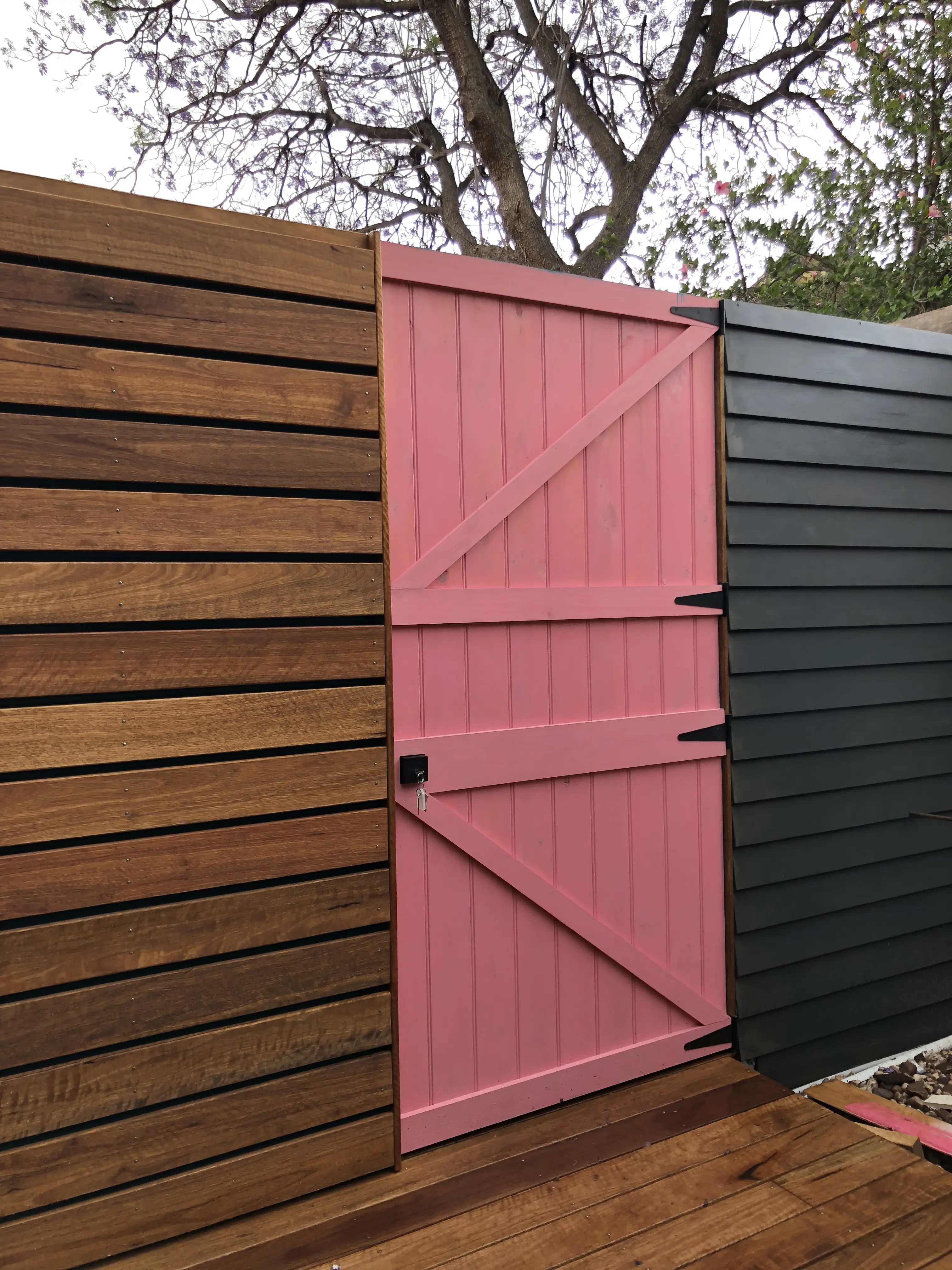 Timber fence and bold pink gate detail